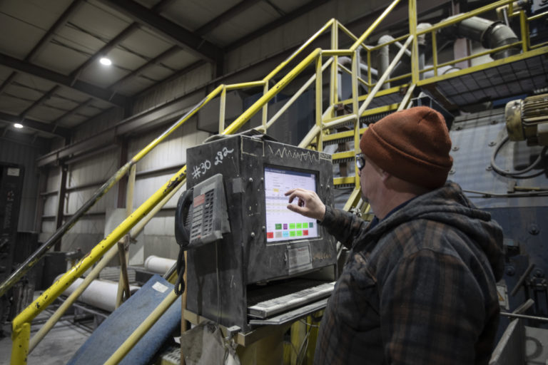 An employee operating a machine.